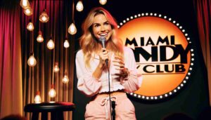 A female Barbie with blonde hair, wearing pink beachwear and a white blouse, performing a stand up routine onstage at the Miami Comedy Club5